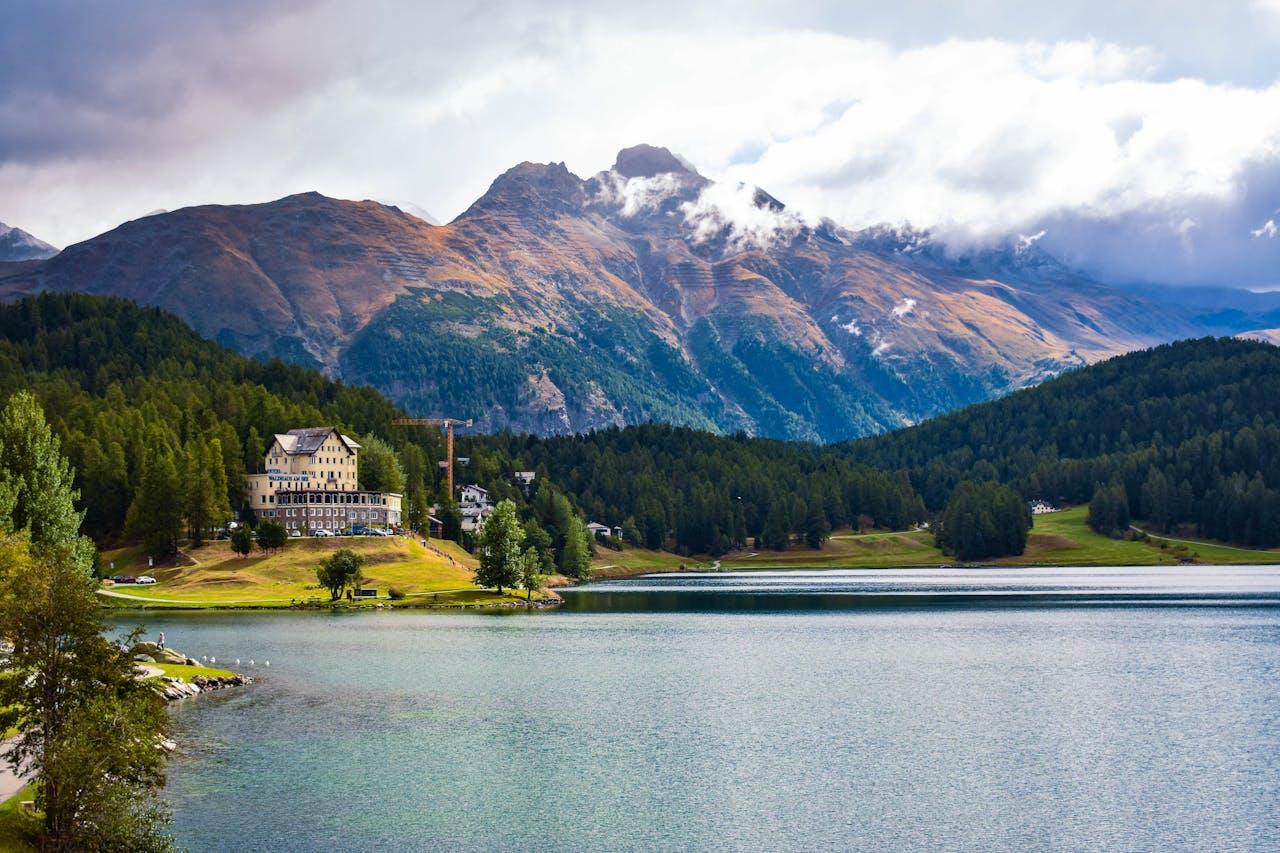 Mountain landscape with lake and hotel.