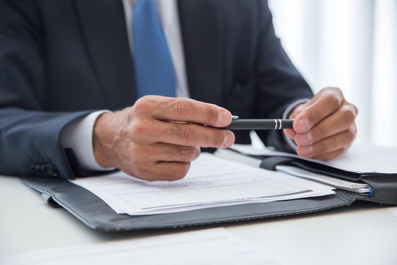 Businessman with contract and pen.