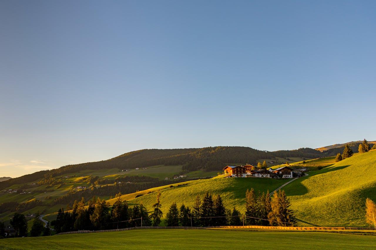 Green hills with buildings.