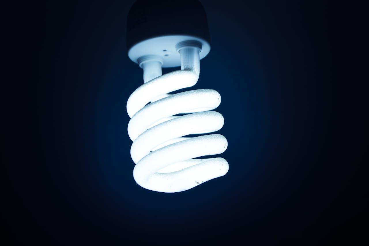 Glowing energy-saving lamp in the dark.